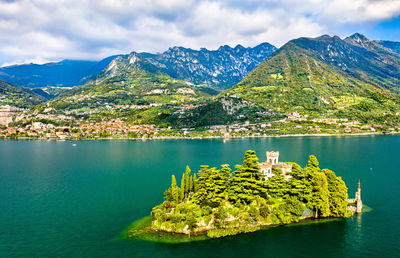 Scenic view of lake by mountains against sky