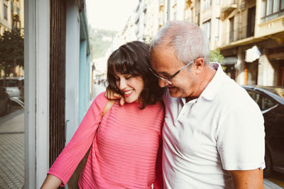 Man and woman wearing hat while standing outdoors