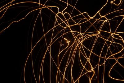 Low angle view of light trails at night