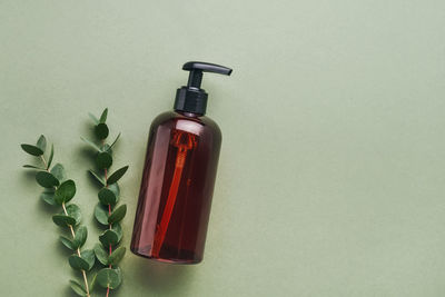 High angle view of bottles on table against white background