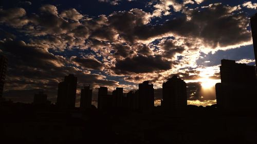 Silhouette buildings against sky during sunset