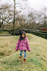 Portrait of a girl standing on field