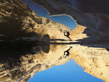 Scenic view of lake surrounded by rocks against clear sky