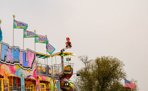 Low angle view of flags against clear sky