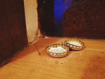 Close-up of wedding rings on table