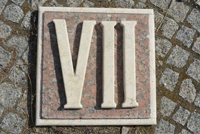 High angle view of text on old stone wall