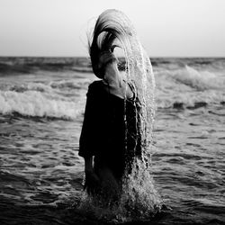 Woman jumping in sea