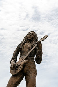 Low angle view of statue against sky