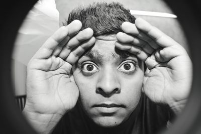 Portrait of young man seen through peephole