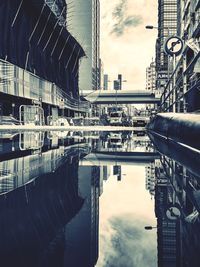 Bridge over river against buildings in city