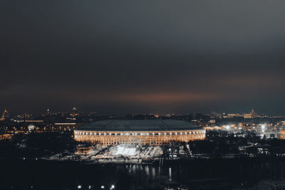 Illuminated buildings against sky at night