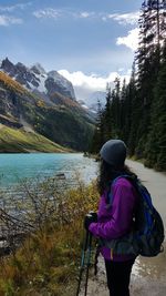 Side view of woman standing on lakeshore