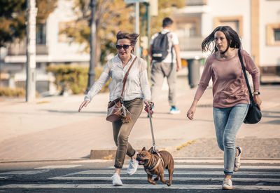 People with dog on street