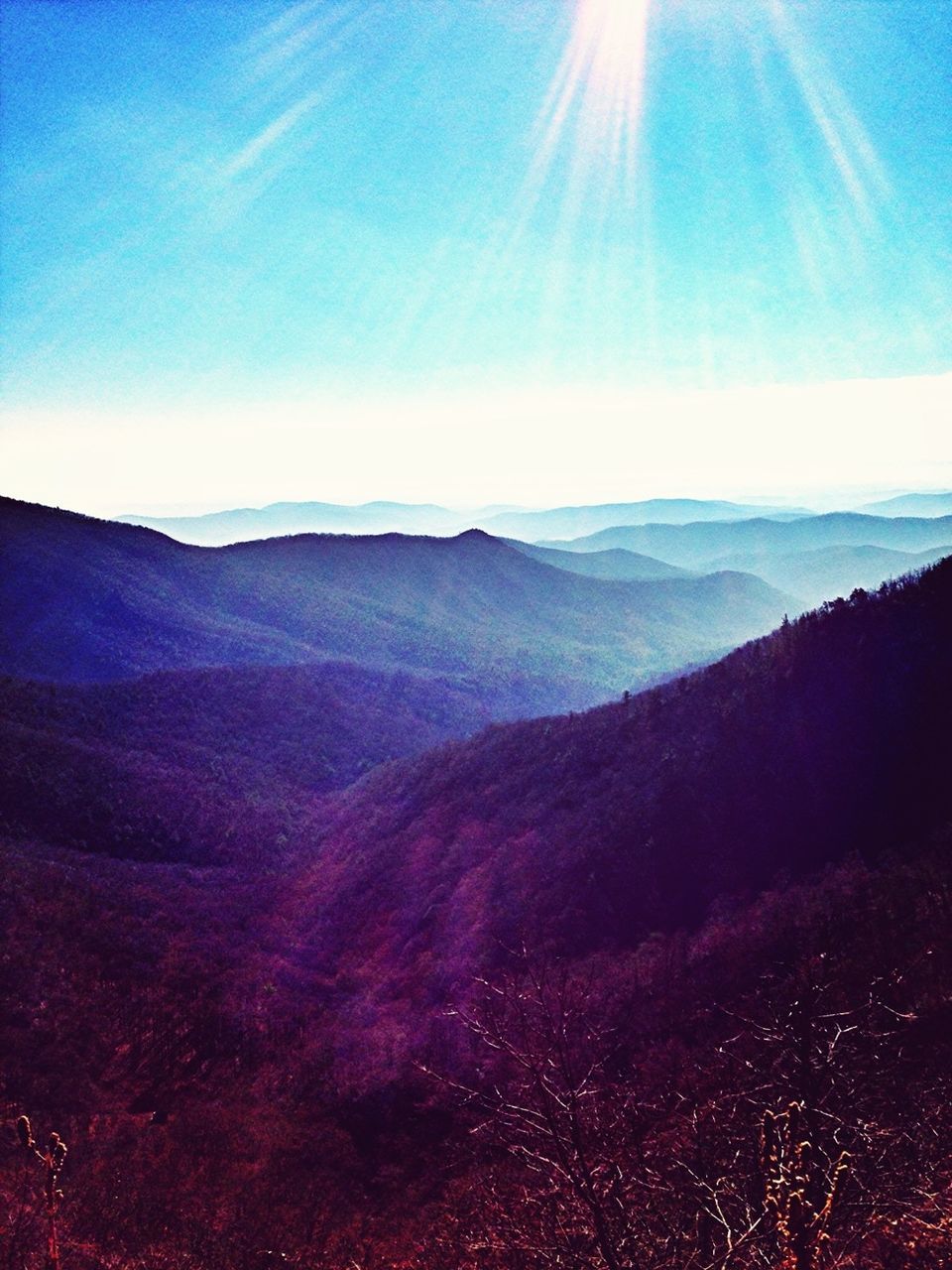 tranquil scene, tranquility, mountain, scenics, beauty in nature, landscape, mountain range, sunbeam, nature, sunlight, sun, blue, non-urban scene, lens flare, idyllic, sky, clear sky, physical geography, remote, outdoors