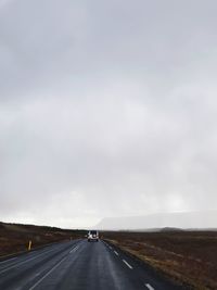 Road passing through landscape against sky