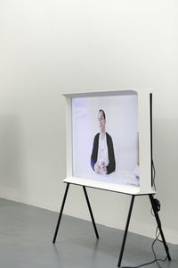 Portrait of young woman sitting on camera