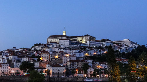 Low angle view of illuminated buildings against clear sky