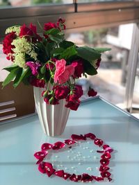 Close-up of red flower vase on table