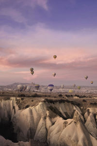 Hot air balloons against sky during sunset