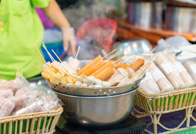 Meat ball and sausage in colander steam for sale in street food market.