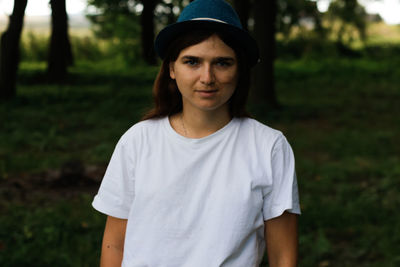 Portrait of young woman standing on field