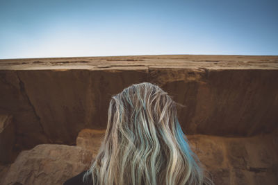 Rear view of woman against sky