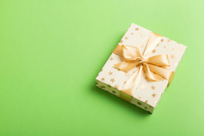 High angle view of gift on yellow background