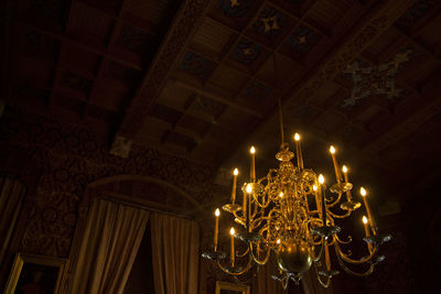 Low angle view of illuminated chandelier in building