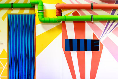 Close-up of pipes on colorful wall