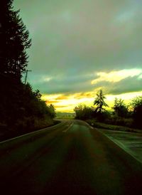 Empty road passing through field