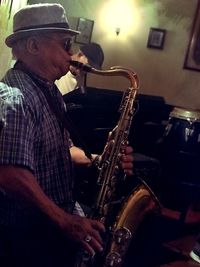 Side view of man playing piano