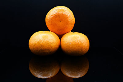 Close-up of oranges against black background