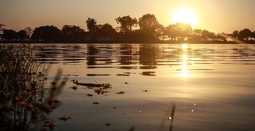 Scenic view of lake against sky during sunset