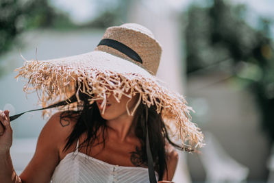 Midsection of woman wearing hat