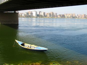 Bridge over river by buildings in city