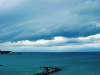 Scenic view of sea against cloudy sky