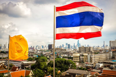 Flag against sky in city