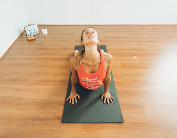 Mid-age woman practicing yoga in a yoga studio