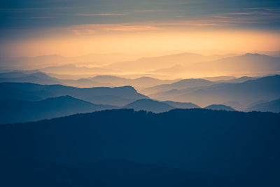 Scenic view of silhouette mountains against sky during sunset