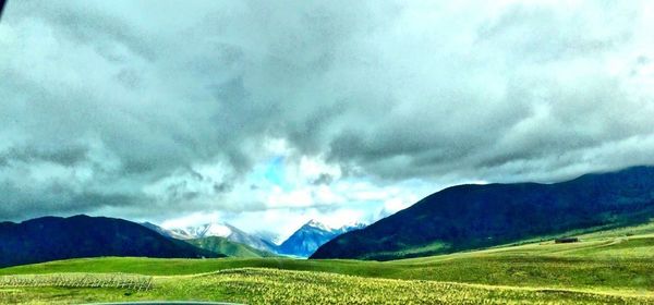 Scenic view of landscape against cloudy sky