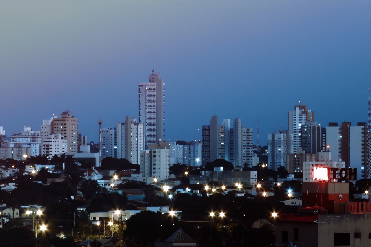 CITYSCAPE AGAINST CLEAR SKY AT NIGHT