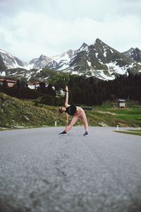 Full length of person on snowcapped mountain against sky