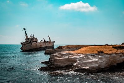 Abandoned ship on sea against sky