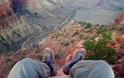 Low section of man on mountain over landscape