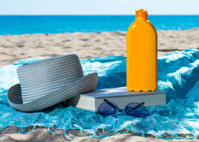 Close-up of sunglasses on beach