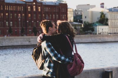 Couple kissing in water at park