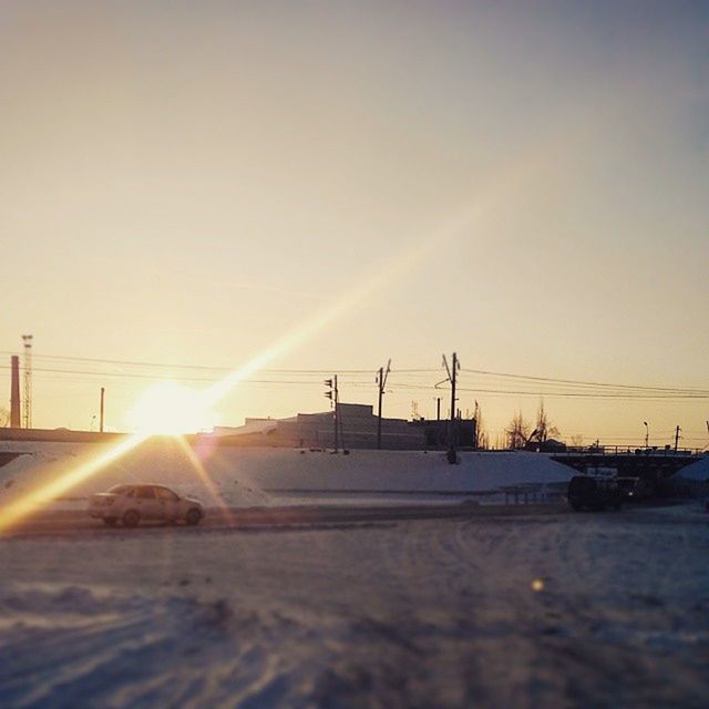 sun, sunset, sunbeam, sunlight, lens flare, transportation, sky, bright, tranquility, scenics, nature, clear sky, tranquil scene, beauty in nature, orange color, silhouette, landscape, road, outdoors, mode of transport