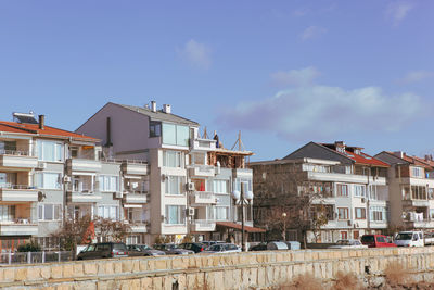 Buildings in town against blue sky