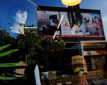 Reflection of building on glass window at restaurant