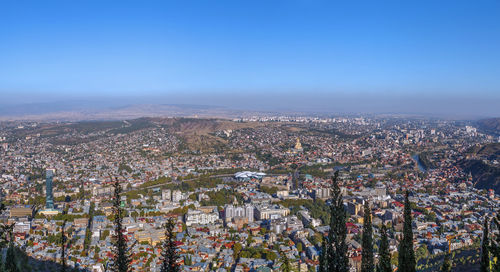 High angle shot of townscape against blue sky